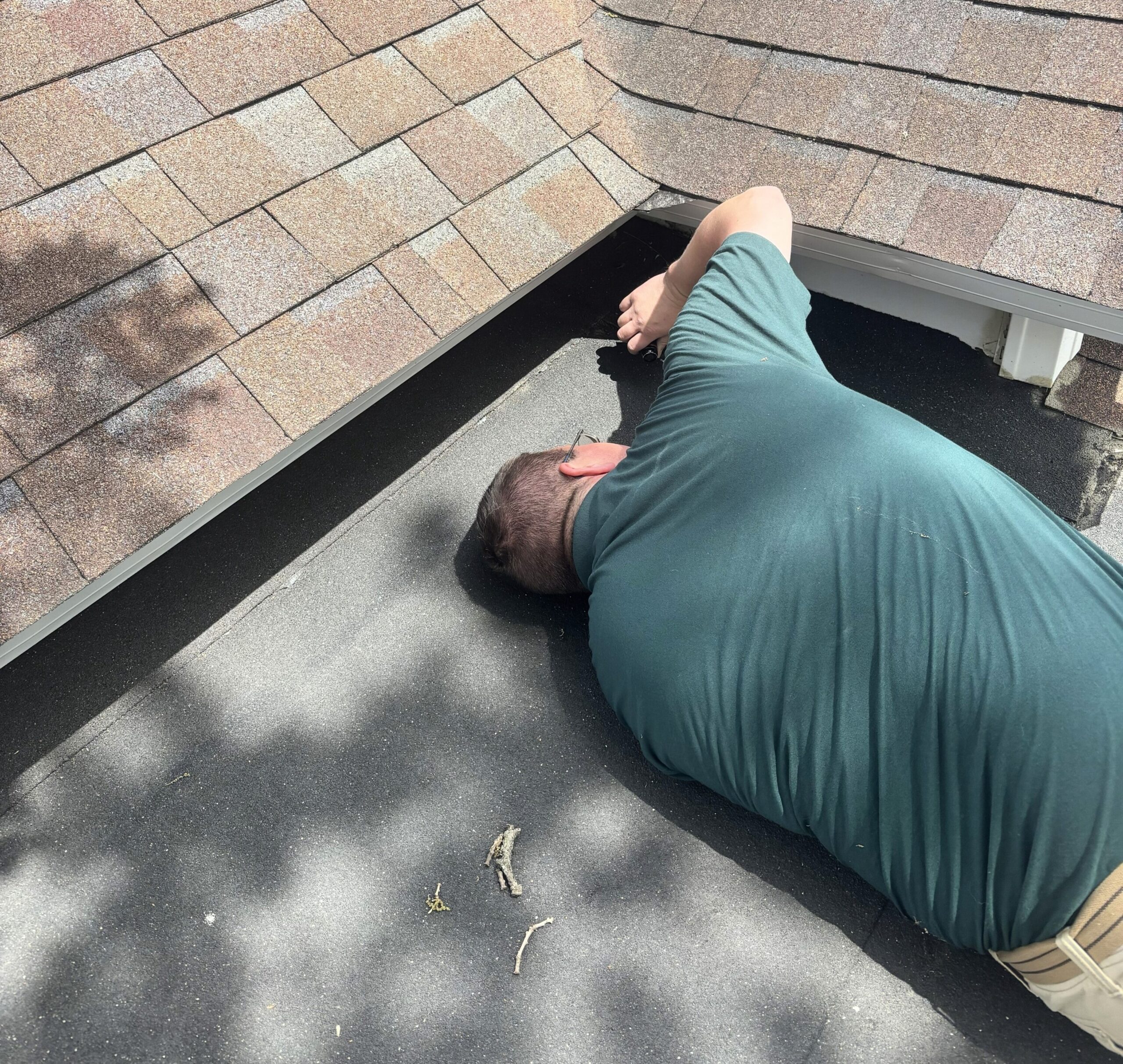 IMG_5573 cropped Professional home inspector performing a roof and flashing inspection on a residential home as part of a comprehensive home inspection by Whitetail Home Inspections.